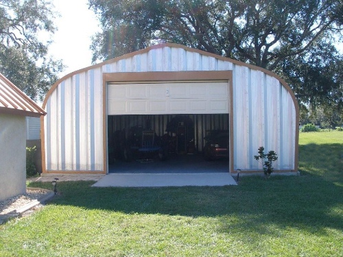 garage conversion ideas in green garden with sliding up door