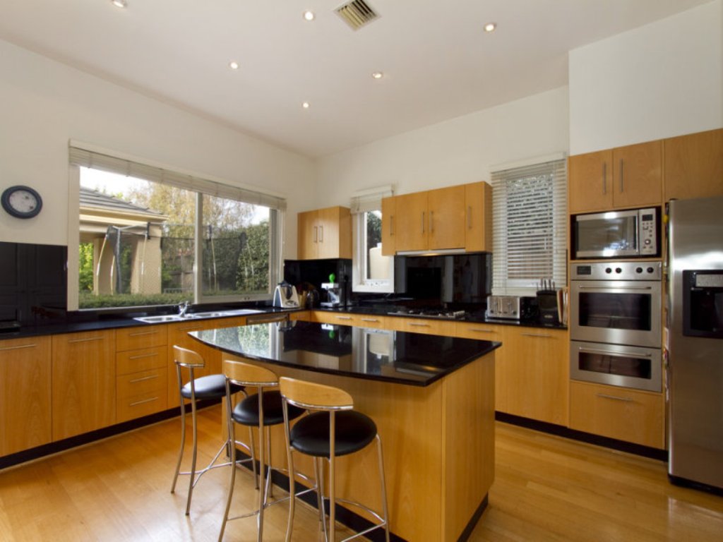 L shaped Kitchen Layout Ideas With Island and brown cabinet and black countertop and backsplash